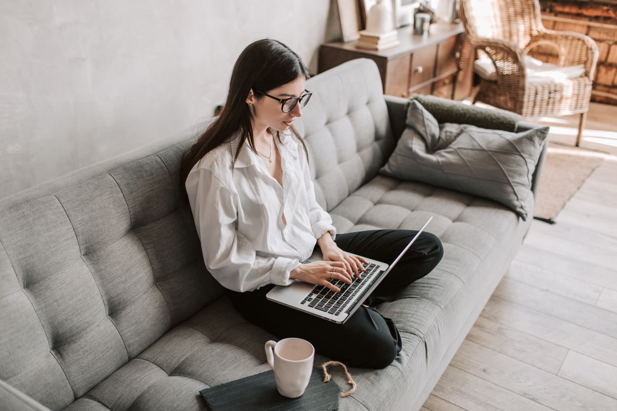 A woman working on a laptop at home