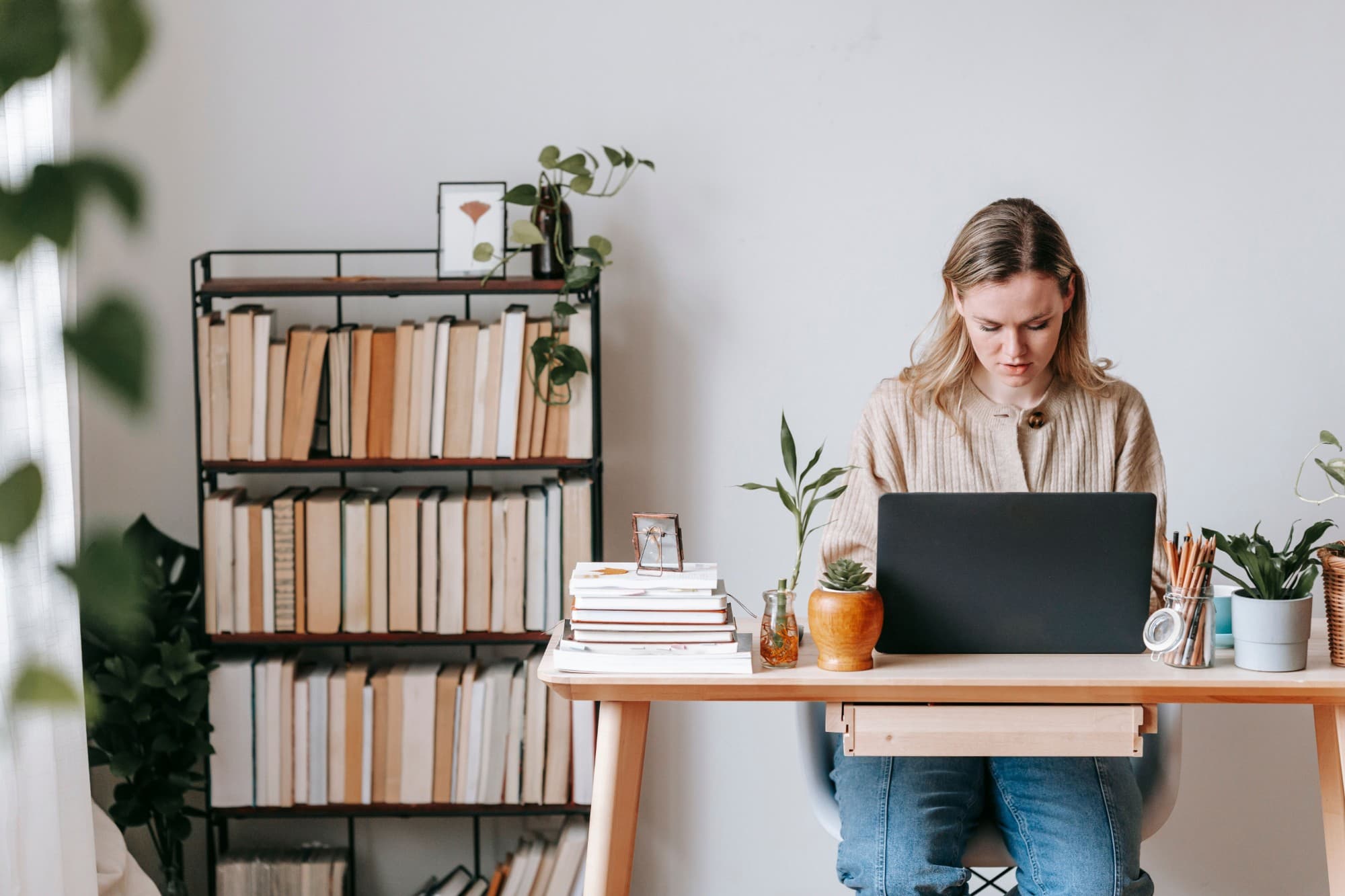 A freelancer working on a laptop at a home desk